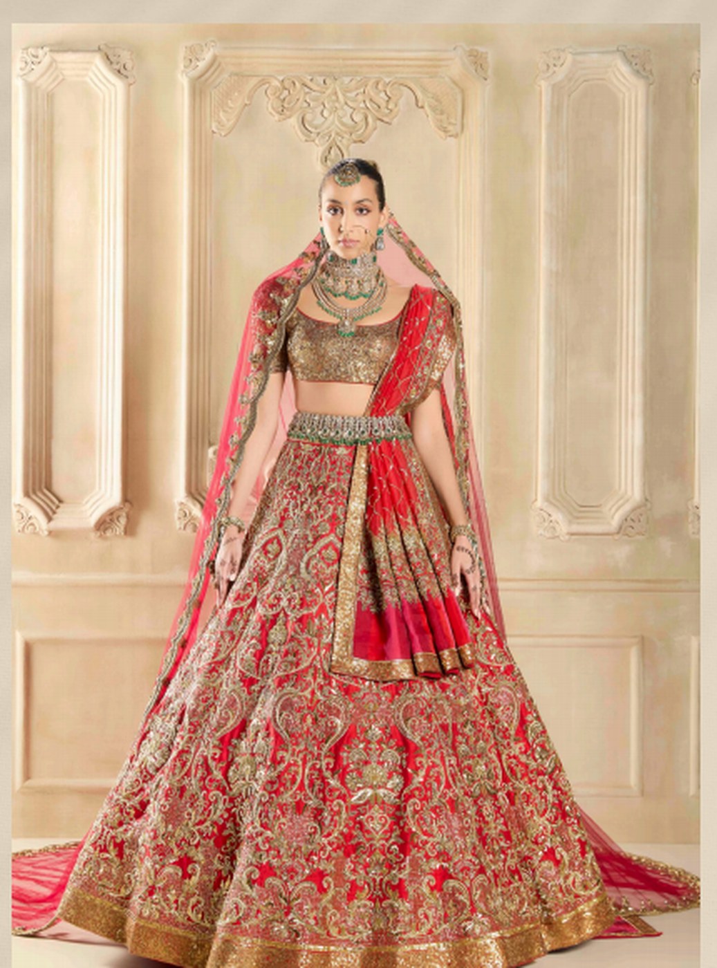 Red and gold bridal ensemble with heavy zari work